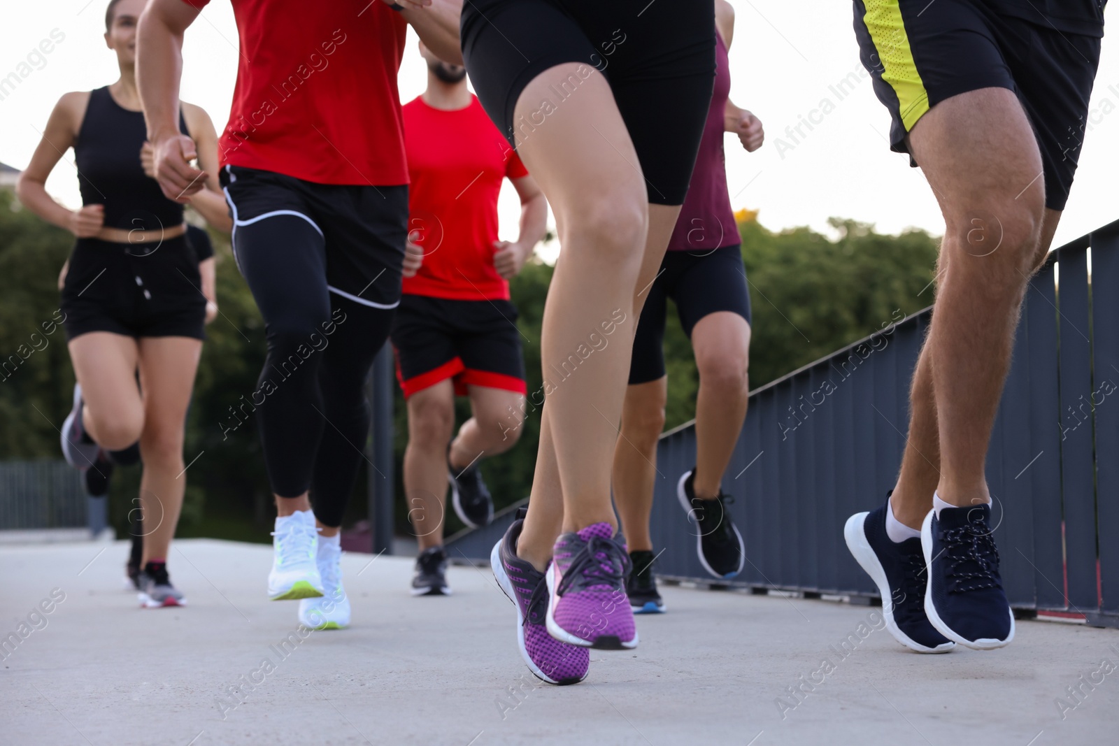 Photo of Group of people running outdoors, closeup view