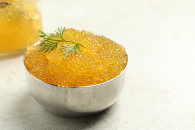 Photo of Fresh pike caviar in bowl on light table, closeup. Space for text