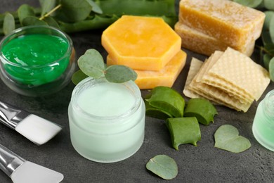 Homemade cosmetic products and fresh ingredients on black table, closeup