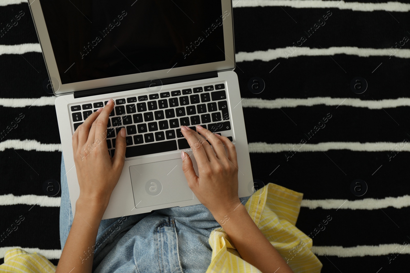 Photo of Woman working with laptop at home, closeup view