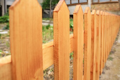 Closeup view of wooden fence outdoors on sunny day