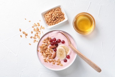 Tasty breakfast with yogurt and granola on table, top view