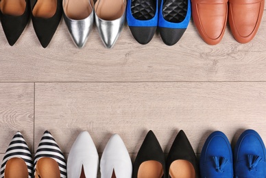 Photo of Different female shoes on wooden background, top view