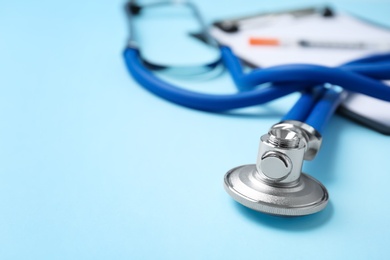 Stethoscope on color background, closeup. Medical equipment