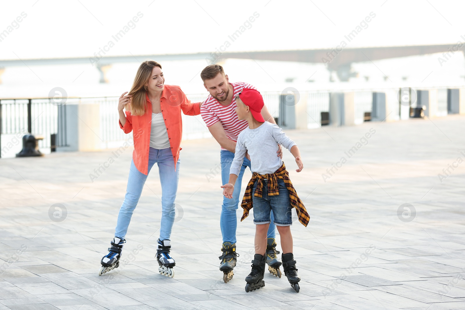 Photo of Happy family roller skating on city street