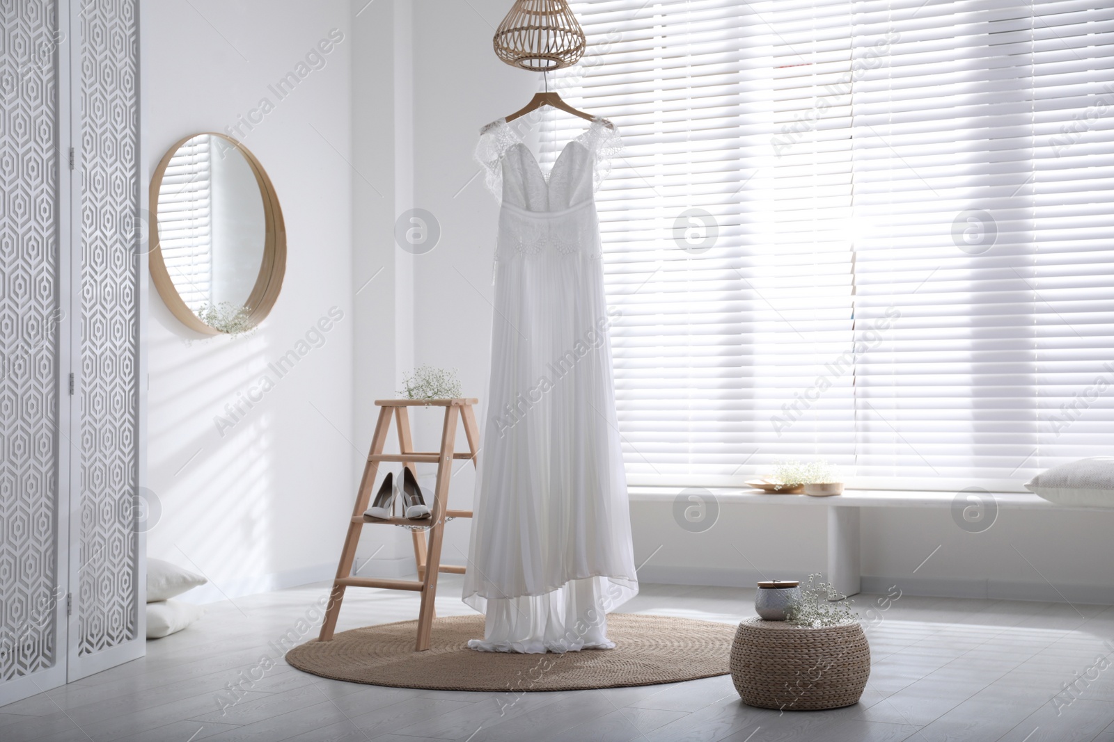 Photo of Beautiful wedding dress, shoes and flowers in room