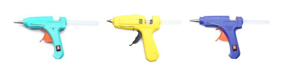 Image of Set with different glue guns with sticks on white background, top view. Banner design