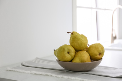 Photo of Fresh ripe pears on countertop in kitchen