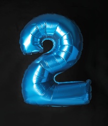 Photo of Blue number two balloon on black background