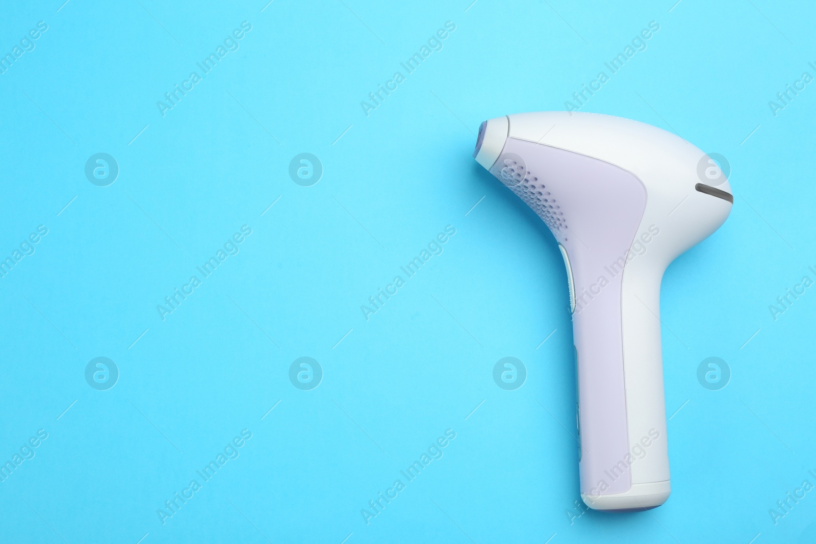 Photo of Modern photoepilator on blue background, top view. Space for text