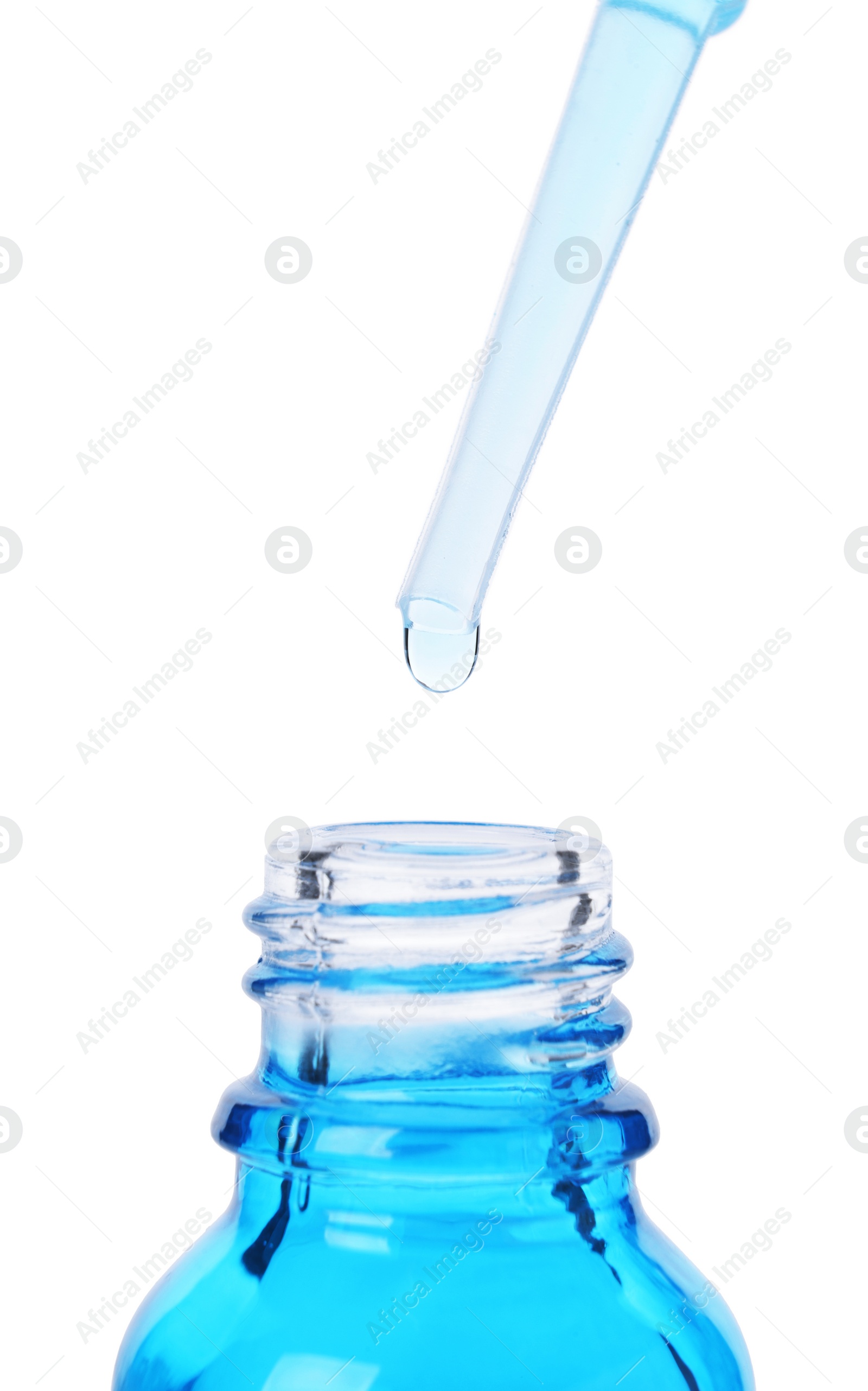 Photo of Dripping liquid from pipette into bottle isolated on white, closeup