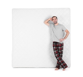 Young man with comfortable mattress isolated on white