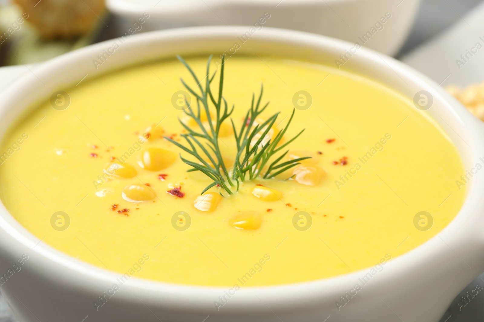 Photo of Delicious creamy corn soup in bowl, closeup