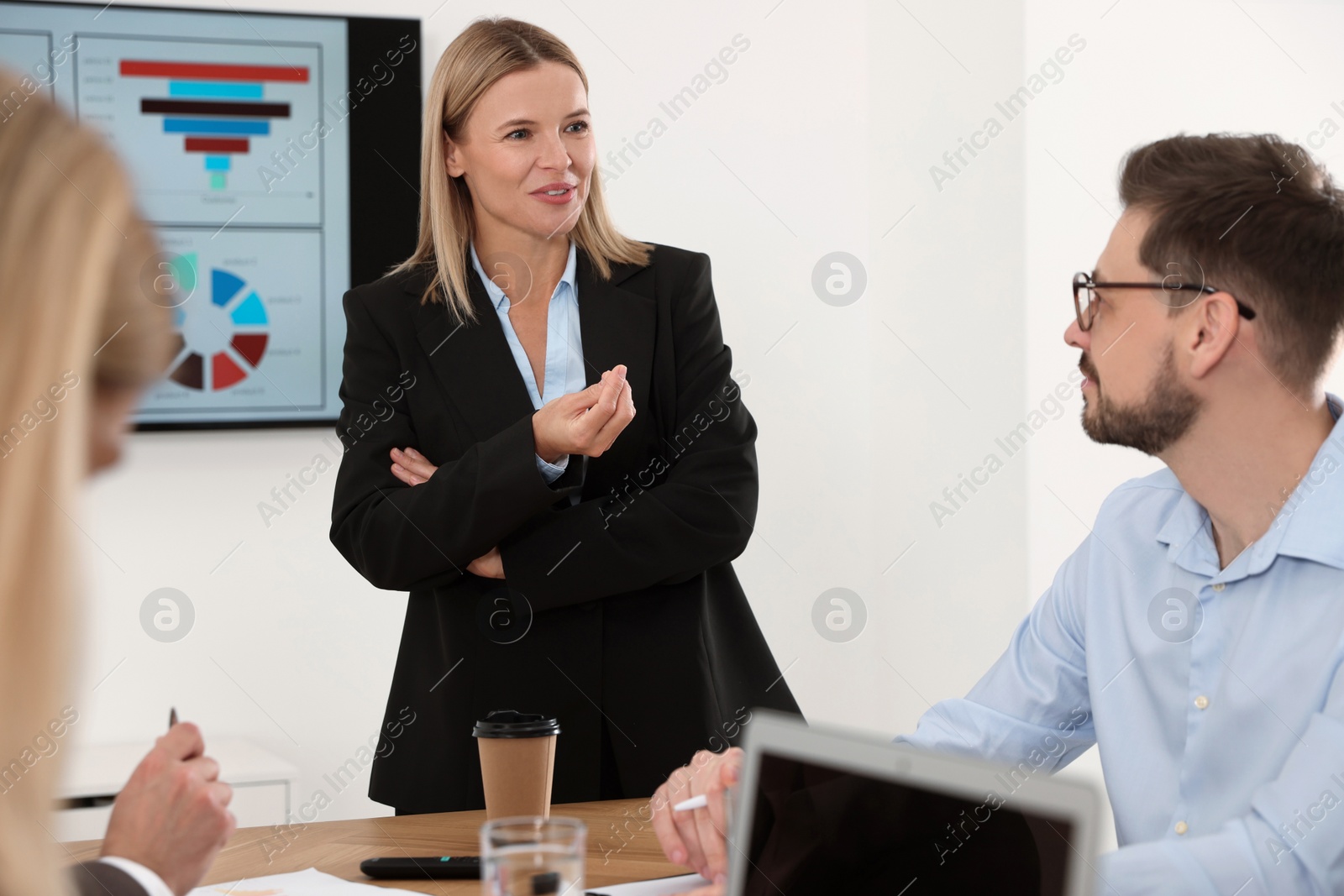 Photo of Businesswoman having meeting with her employees in office