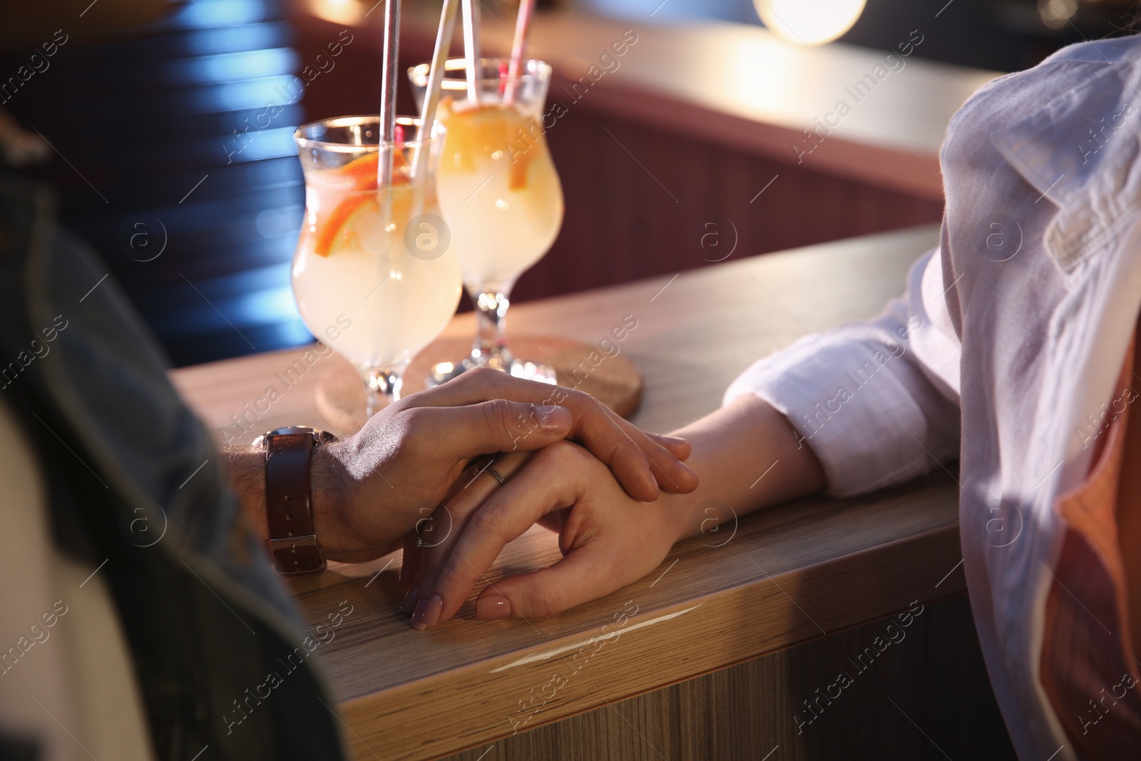 Photo of Man and woman flirting with each other in bar, closeup