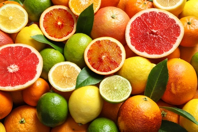 Photo of Different citrus fruits as background, top view