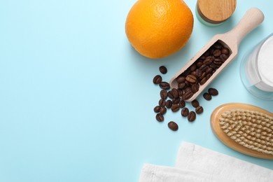 Photo of Coffee beans, orange and brush on light blue background, flat lay with space for text. Anti cellulite treatment