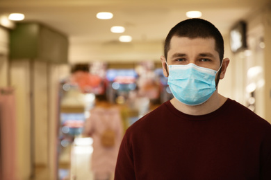 Man wearing disposable mask indoors. Dangerous virus