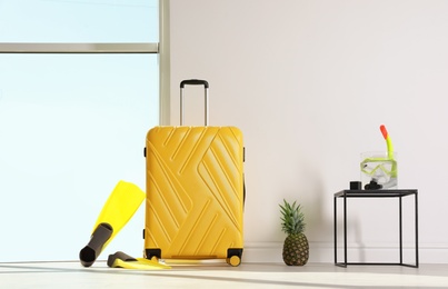 Photo of Large suitcase for travelling and beach items indoors