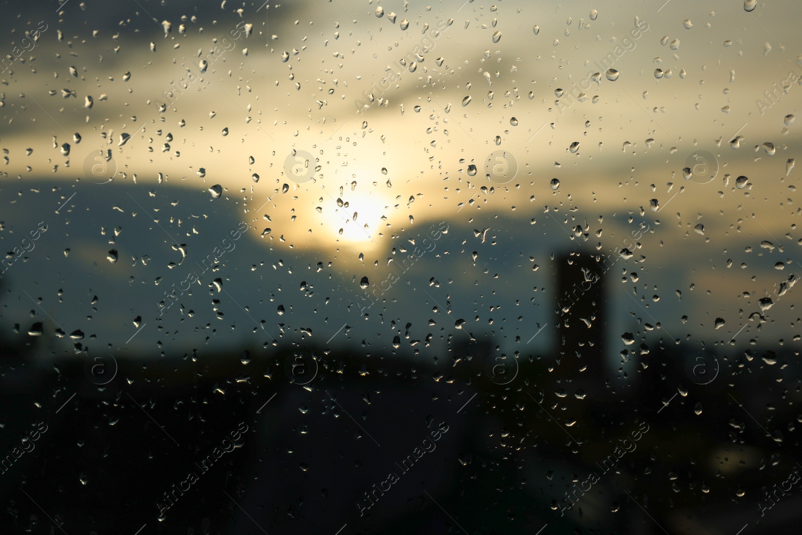 Photo of Window glass with droplets on rainy day, closeup