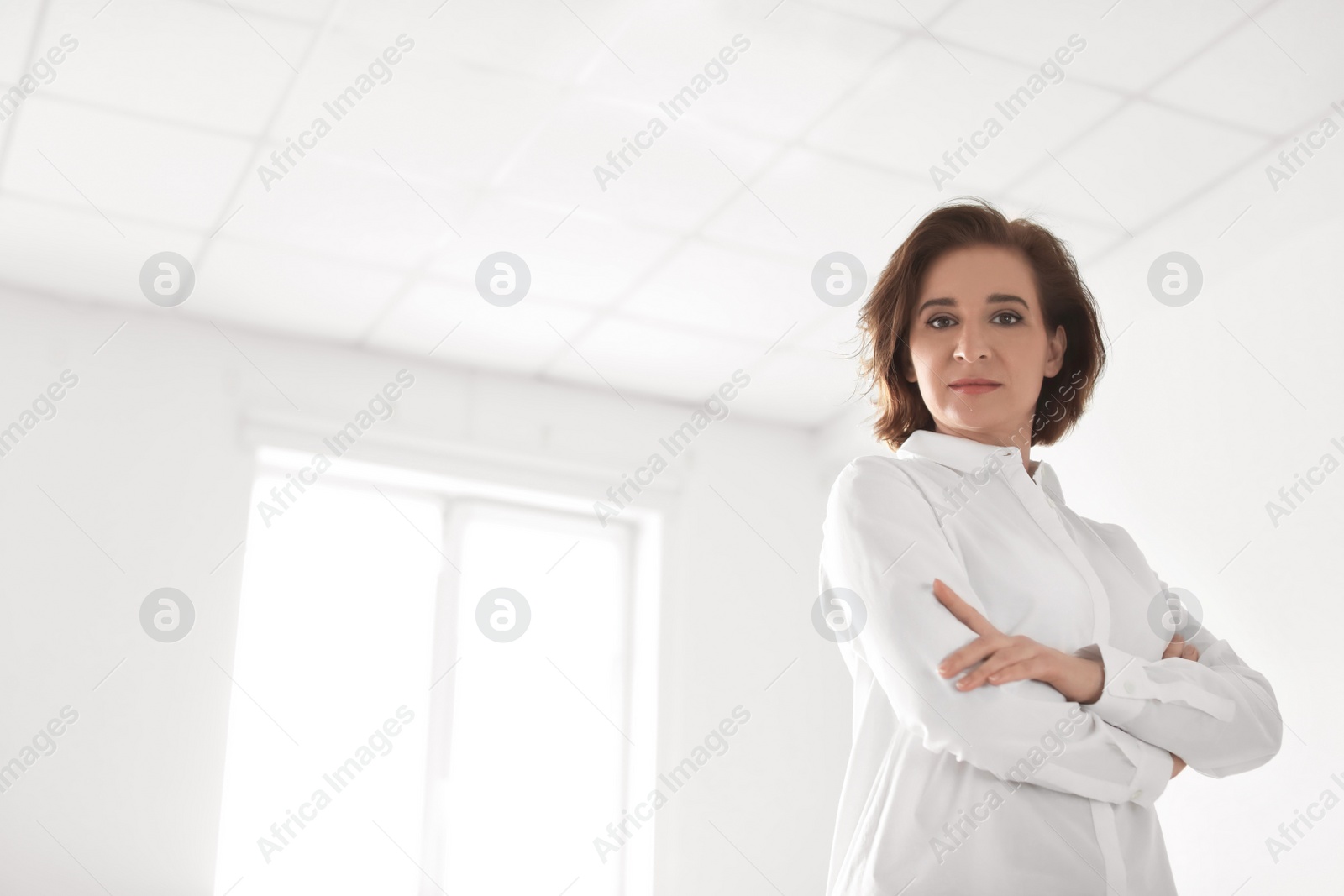 Photo of Female lawyer standing in light office