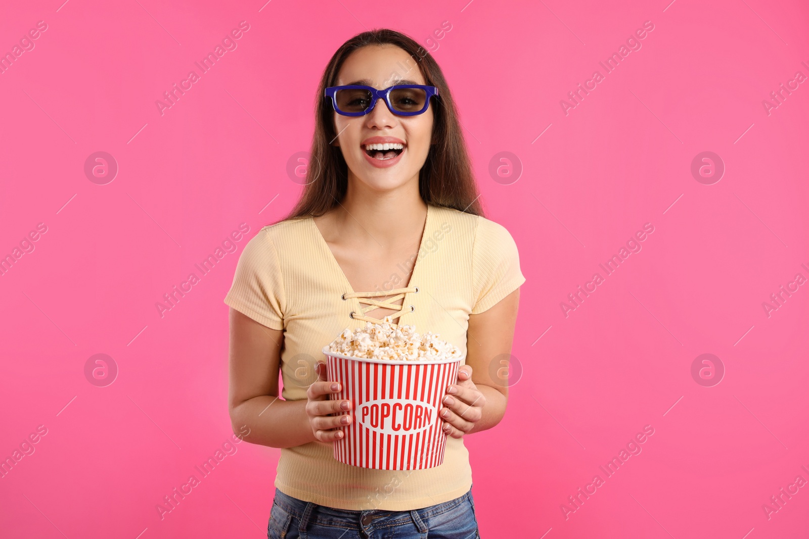 Photo of Woman with 3D glasses and popcorn during cinema show on color background