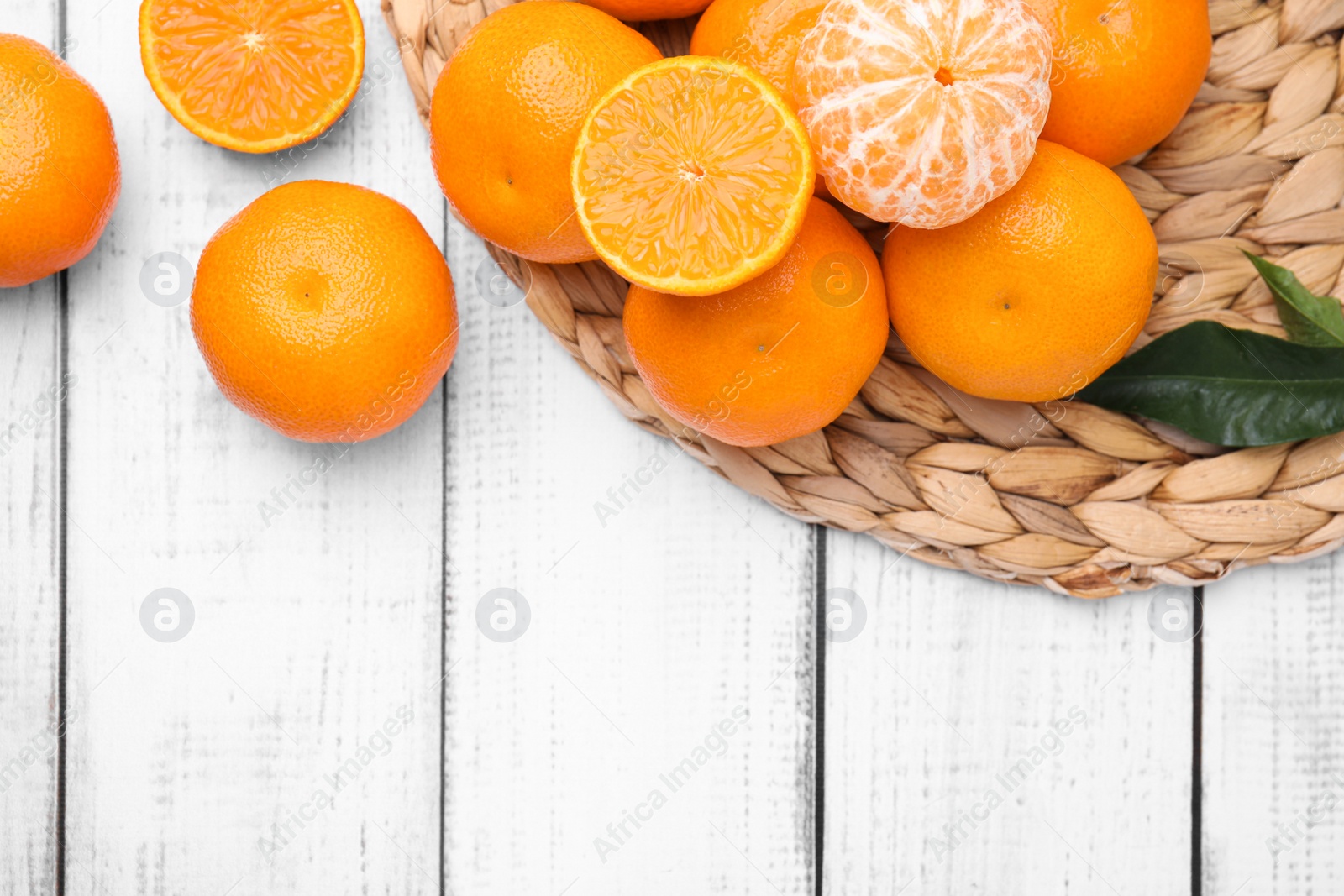 Photo of Fresh juicy tangerines on white wooden table, flat lay. Space for text