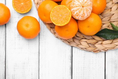 Fresh juicy tangerines on white wooden table, flat lay. Space for text