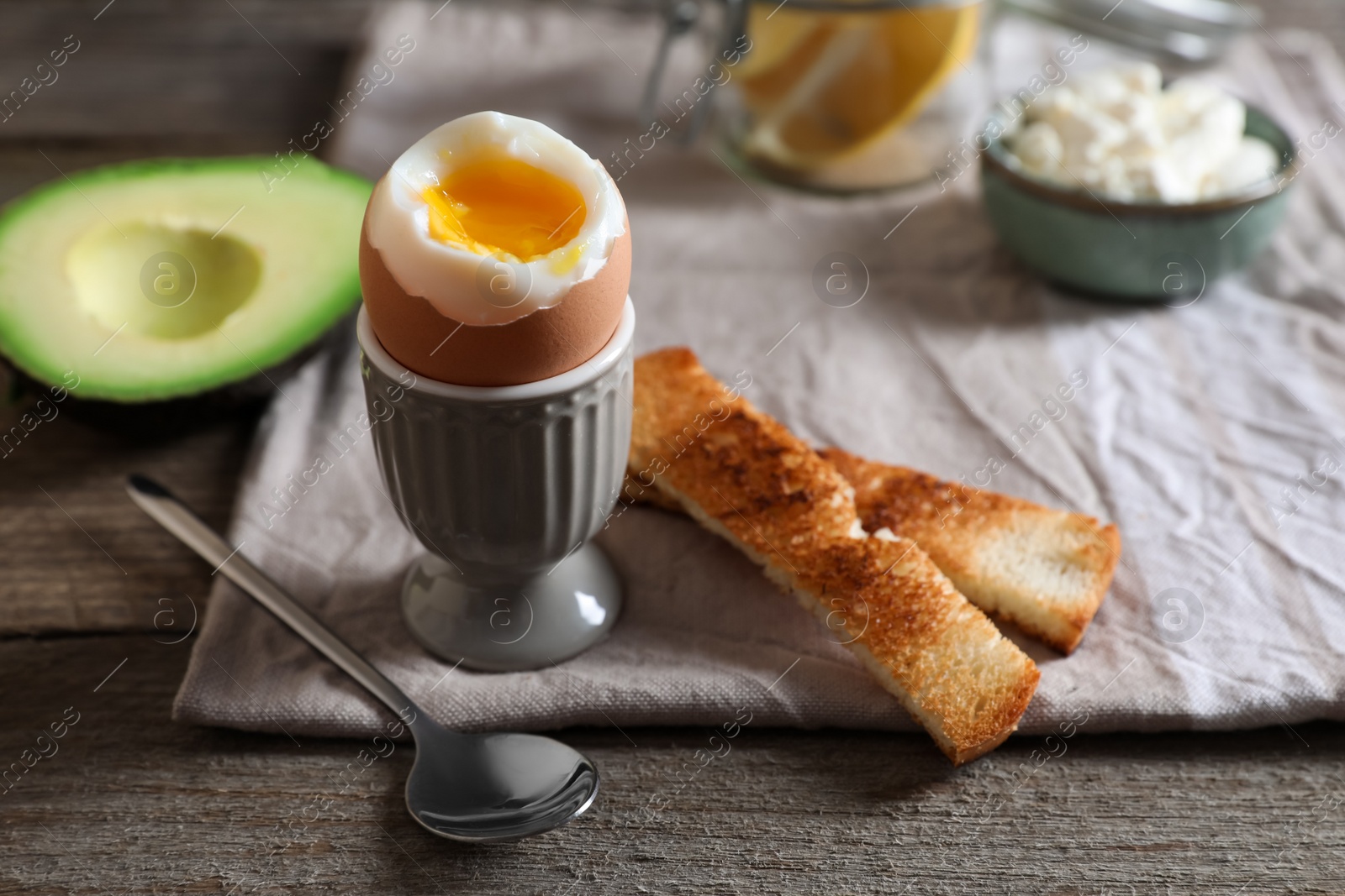 Photo of Soft boiled egg served for breakfast on wooden table