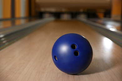 Blue ball on bowling lane in club