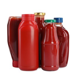 Different bottles of ketchup on white background