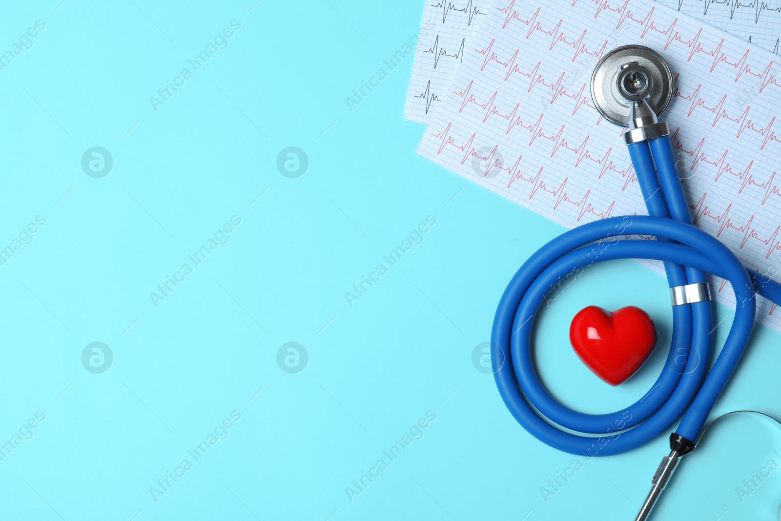 Photo of Stethoscope with red heart and cardiogram on blue background, flat lay. Space for text