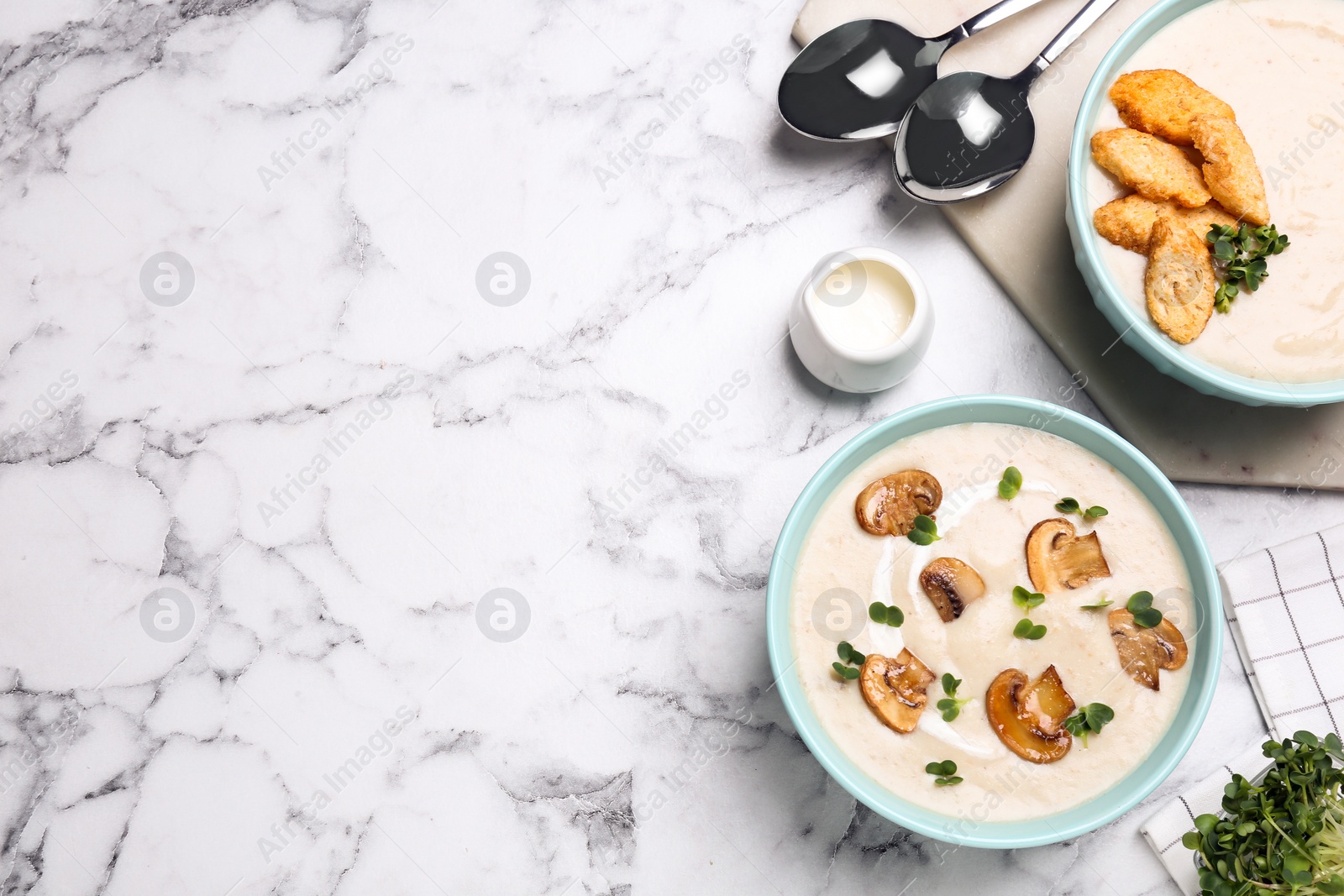 Photo of Delicious cream soup with mushrooms served on white marble table, flat lay. Space for text
