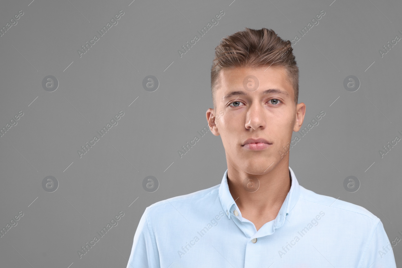 Photo of Portrait of handsome young man on grey background, space for text