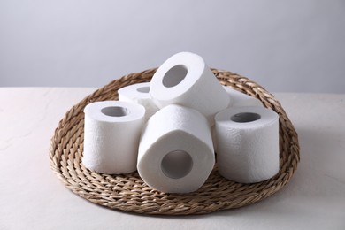 Many toilet paper rolls on white table