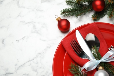 Photo of Festive table setting with beautiful dishware and Christmas decor on white marble background, flat lay. Space for text