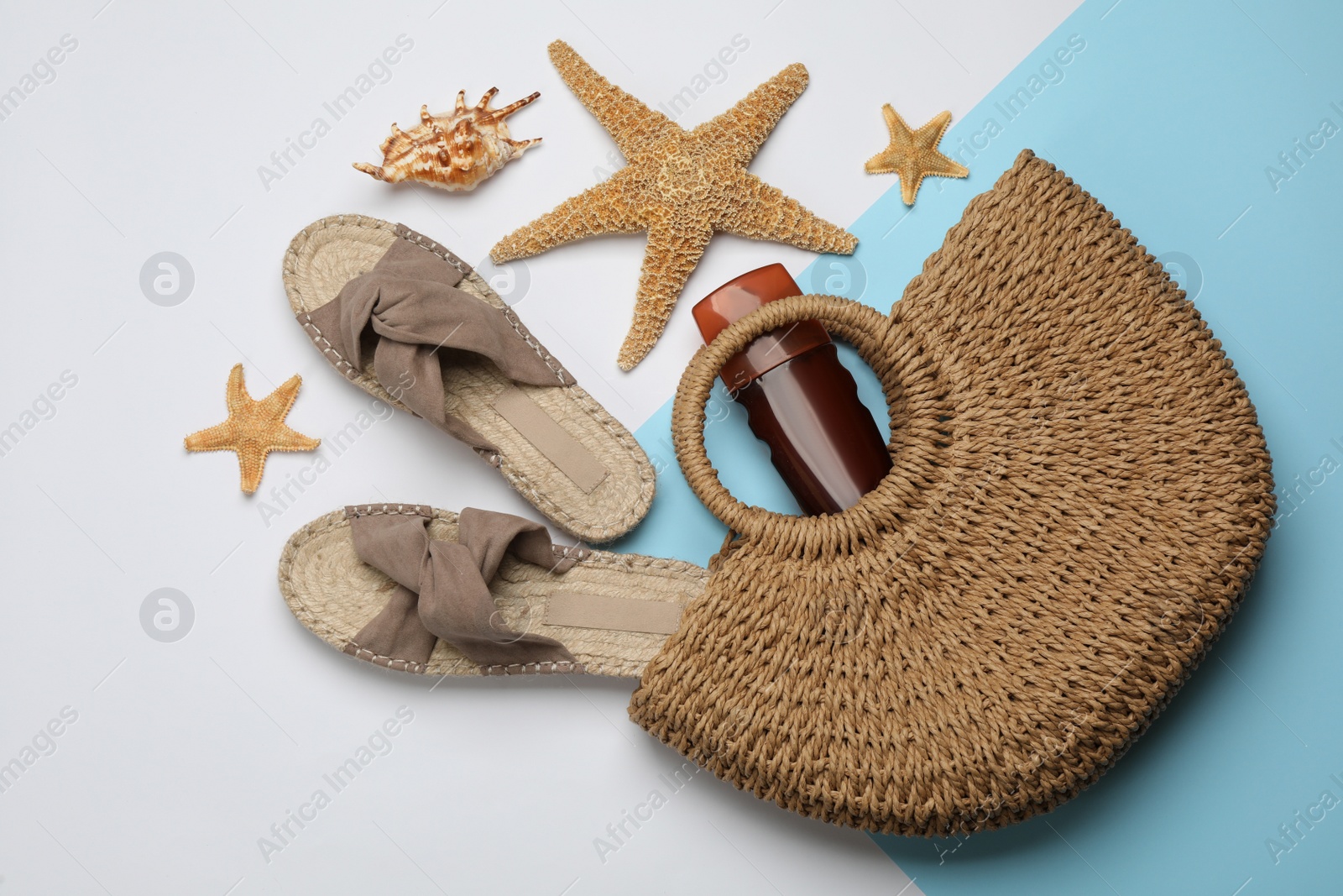 Photo of Stylish bag and beach accessories on color background, flat lay