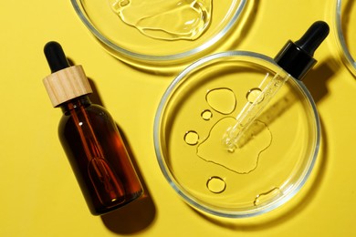 Flat lay composition with Petri dishes on yellow background