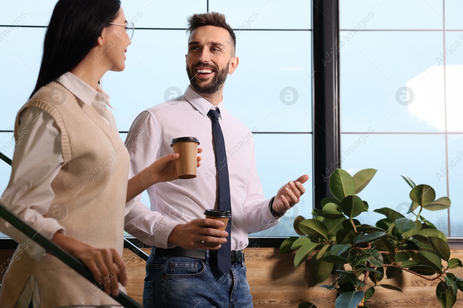 Photo of Coworkers talking during coffee break in office