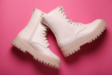 Photo of Pair of stylish leather shoes on pink background, flat lay