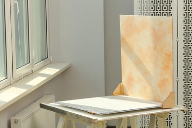 Photo of Double-sided backdrop on table in photo studio. Space for text
