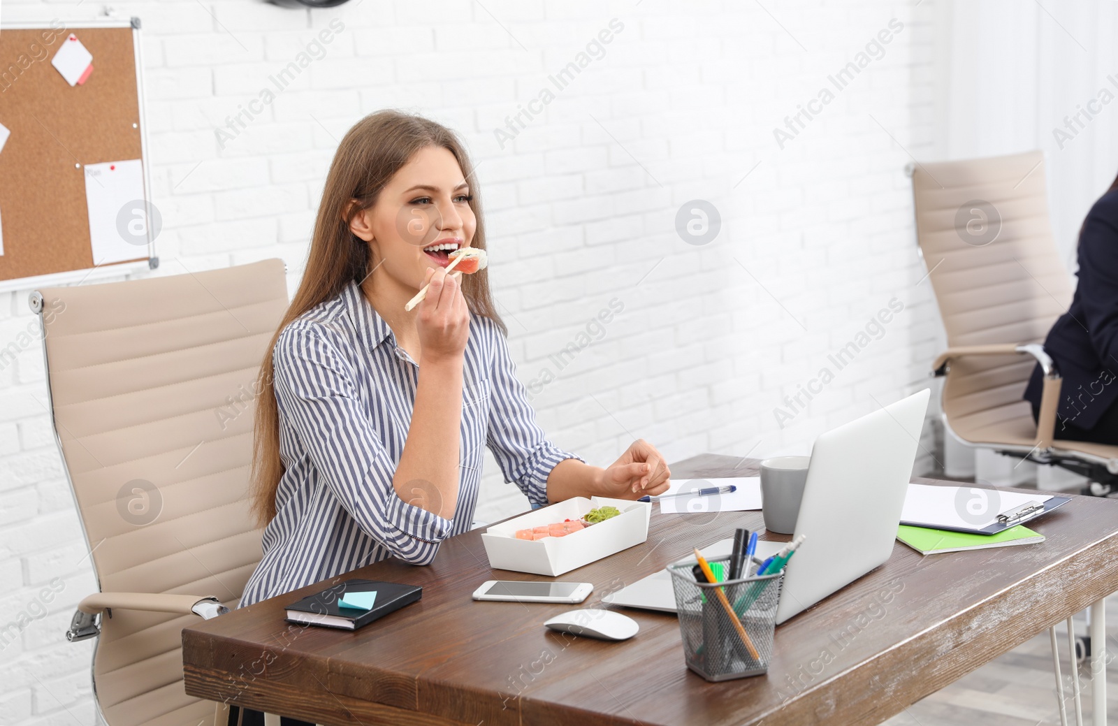 Photo of Office employee having lunch at workplace. Food delivery