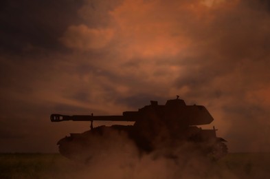 Image of Silhouette of tank on battlefield in night