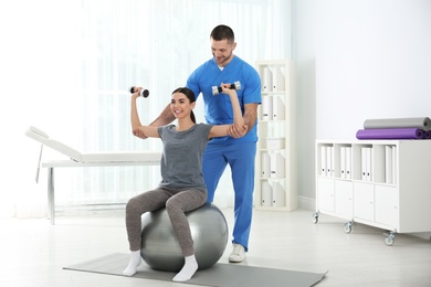 Doctor working with patient in hospital. Rehabilitation exercises