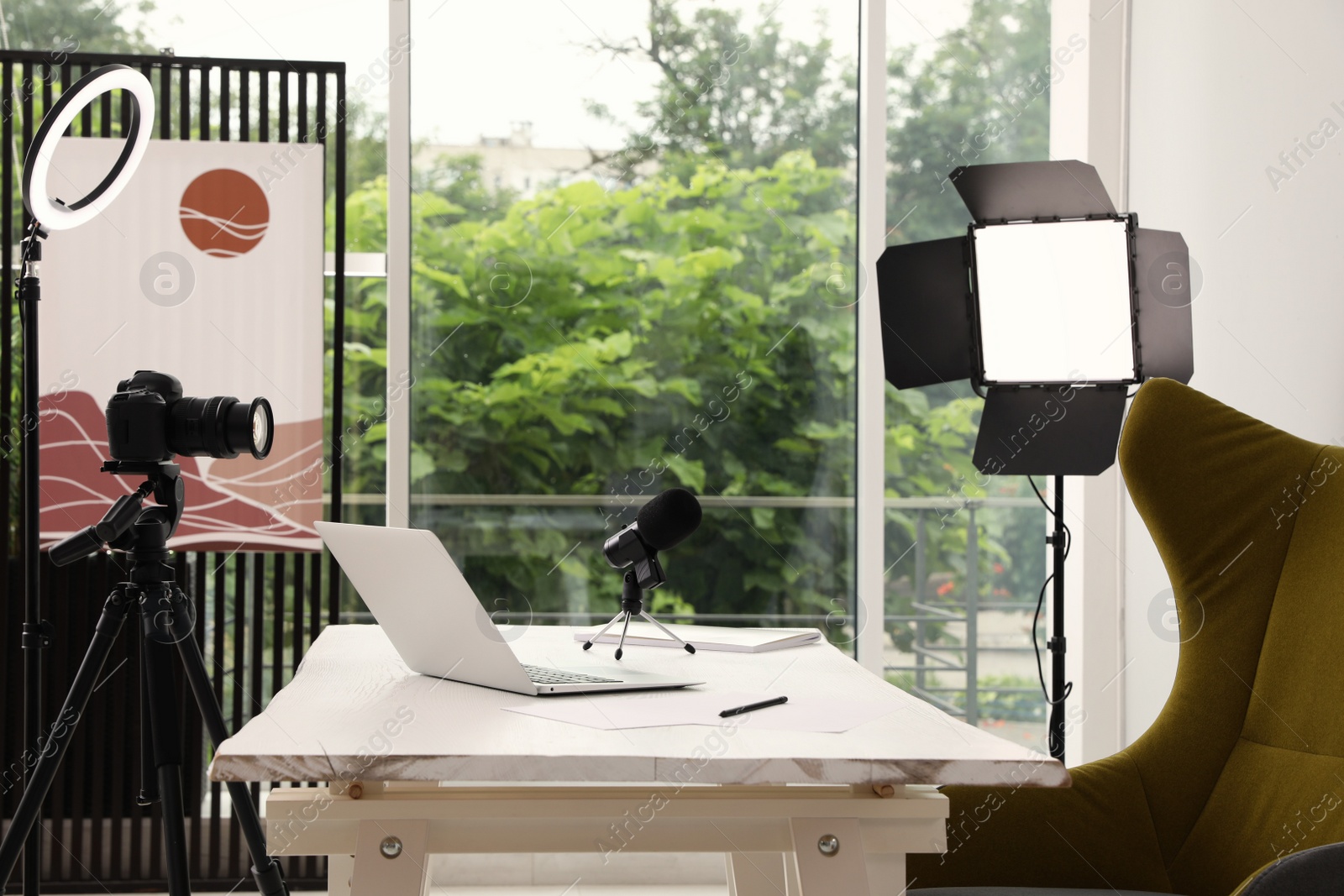 Photo of Modern blogger's workplace with professional equipment and laptop in room