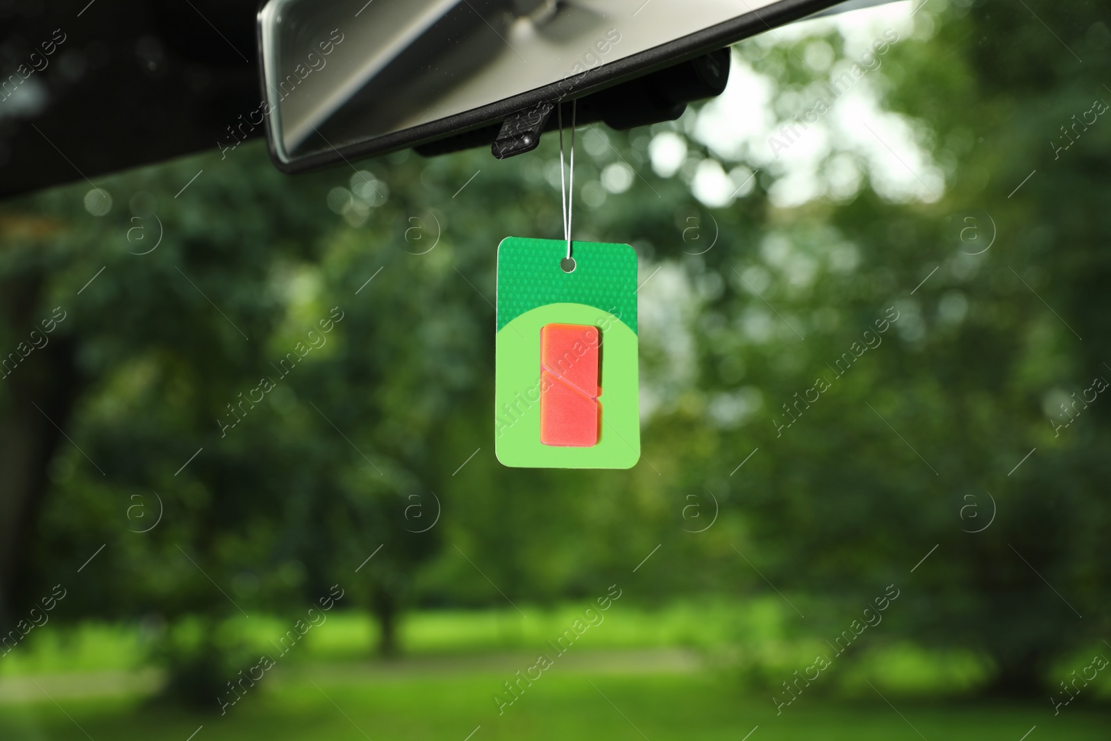 Photo of Air freshener hanging in car against windshield