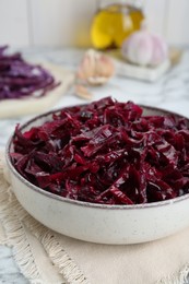 Tasty red cabbage sauerkraut on white marble table, closeup