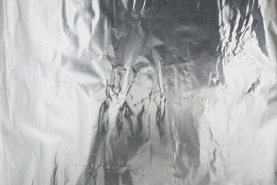 Photo of Crumpled silver foil as background, top view