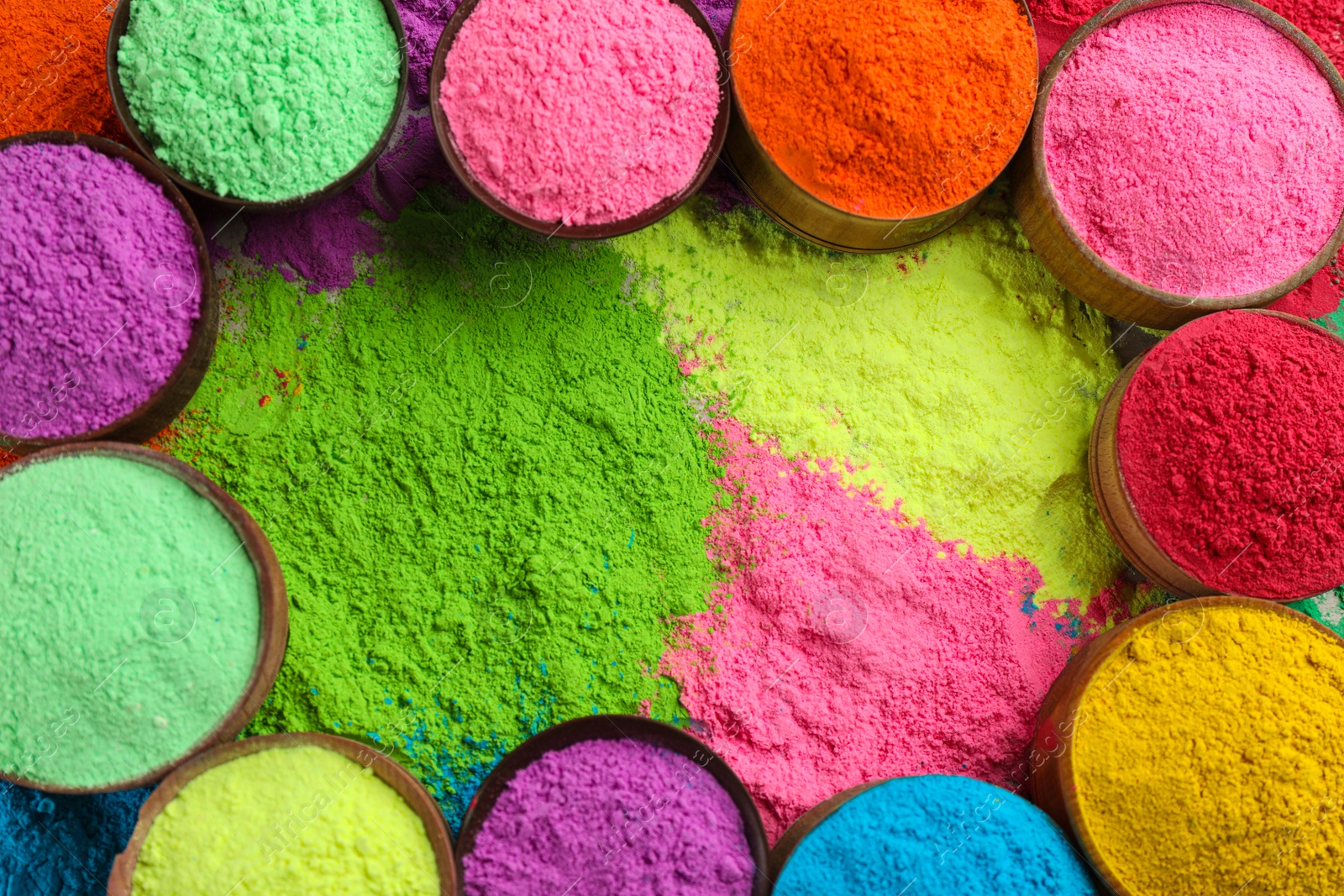 Photo of Colorful powder dyes as background, top view. Holi festival