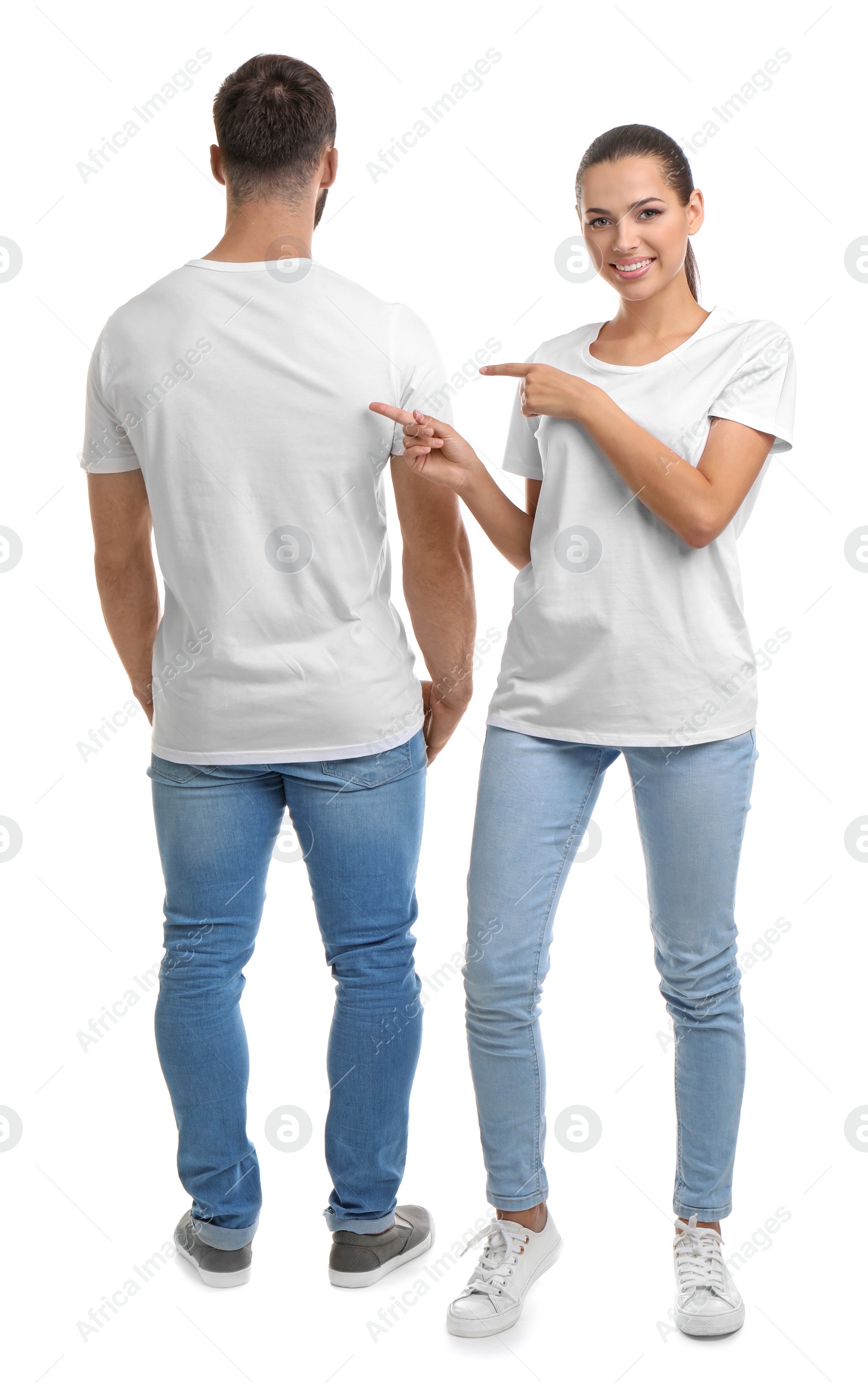 Photo of Young couple in t-shirts on white background. Mockup for design